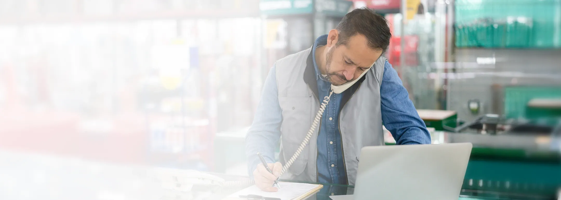 Business owner at a hardware store talking on phone